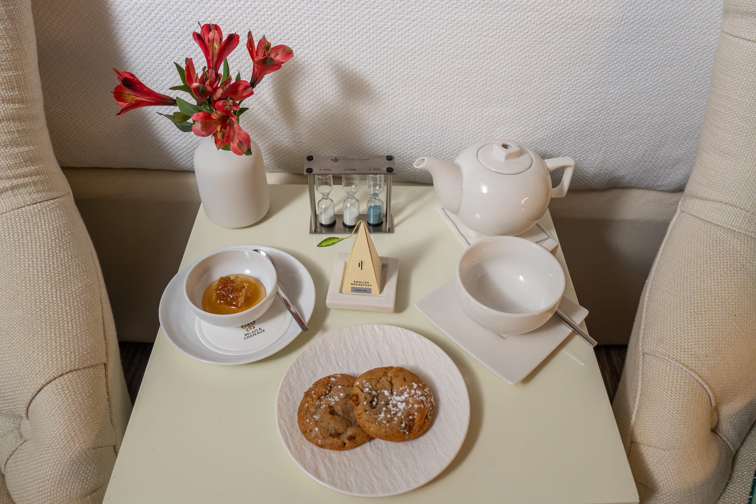Cookies, honey comb, and chocolate on a room side table included in your fee when you stay at Chatham Inn