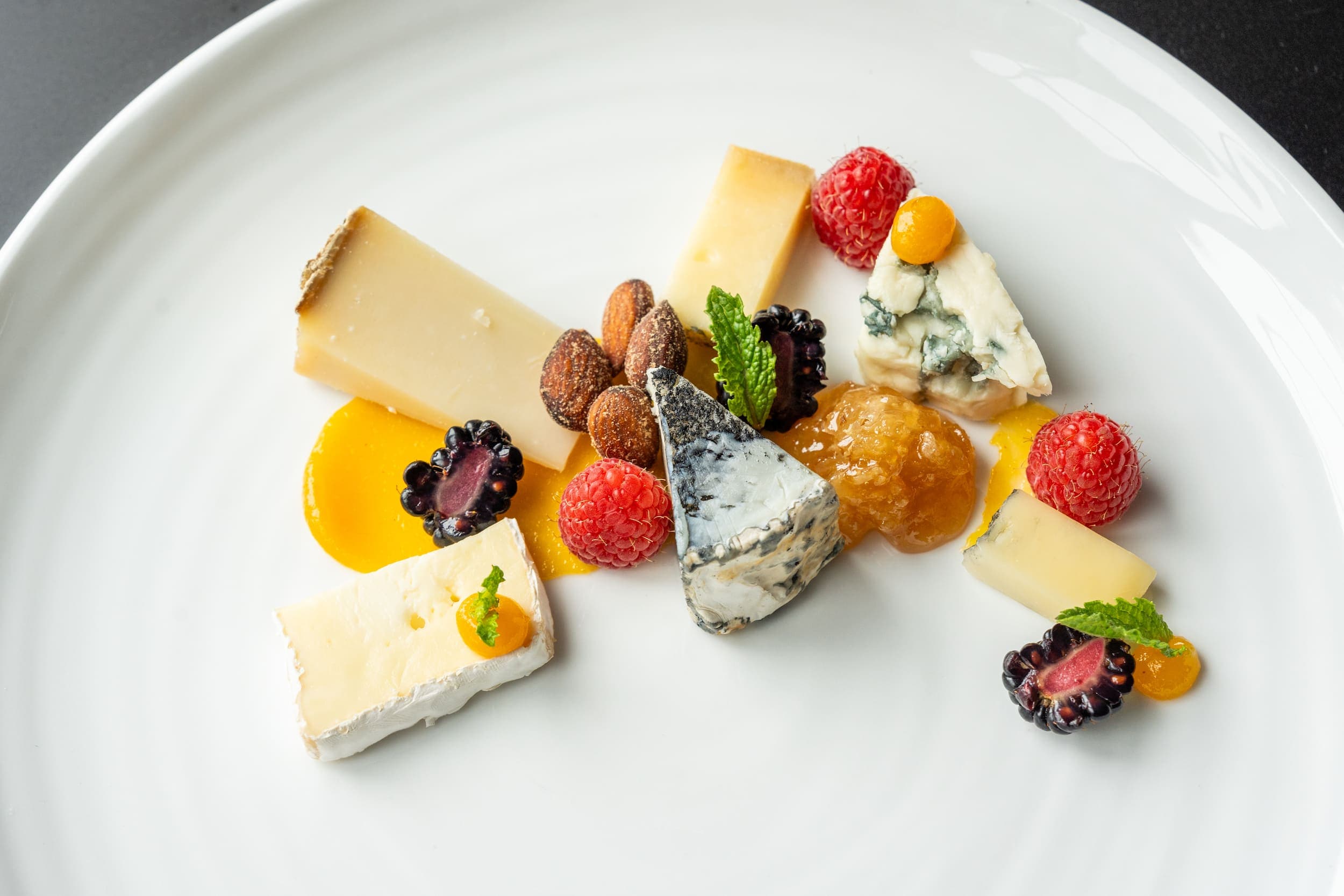 A Cheese And Fruit Plate with nuts and jams at Chatham Inn
