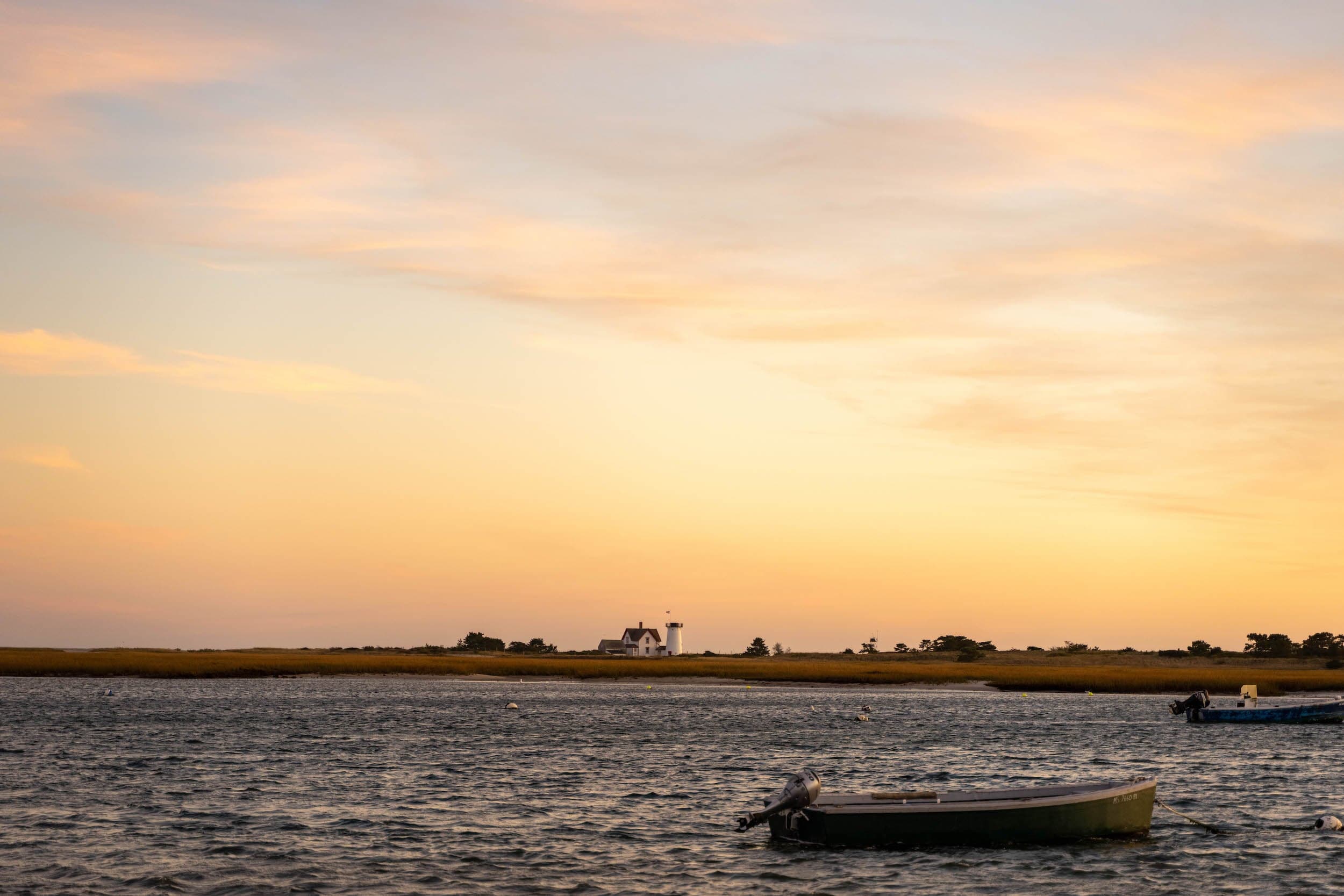 a few fishing boats in the water at sunset near Chatham Inn