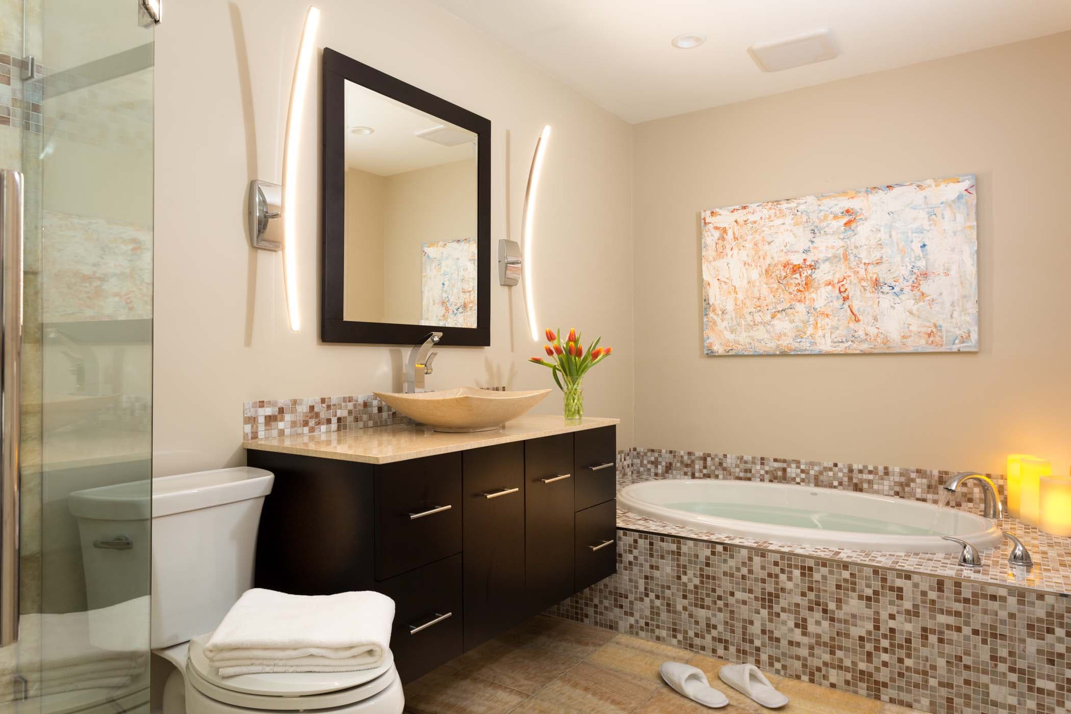 The washroom in room 11 with a separate tub and shower and large vanity area at Chatham Inn