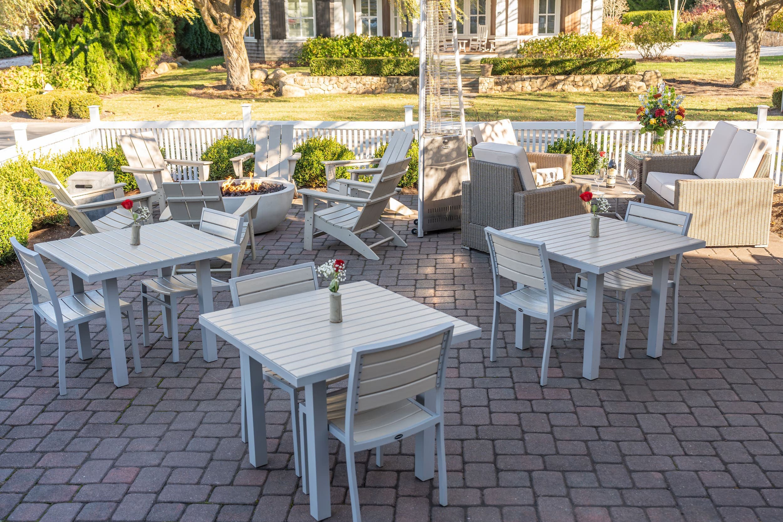 The patio on Main with vases of flowers and plenty of seating