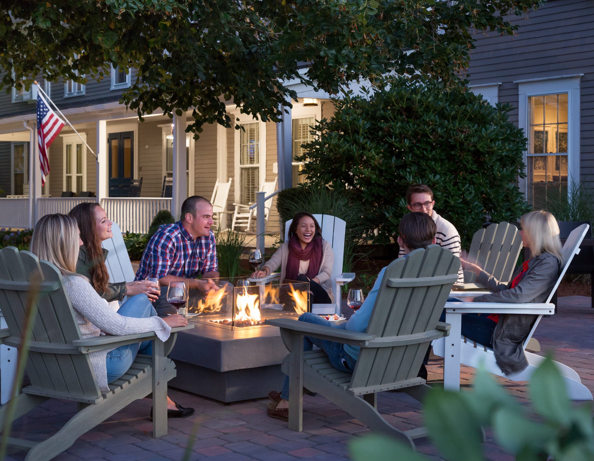 A group of people having a great time around an outdoor fire pit at Chatham