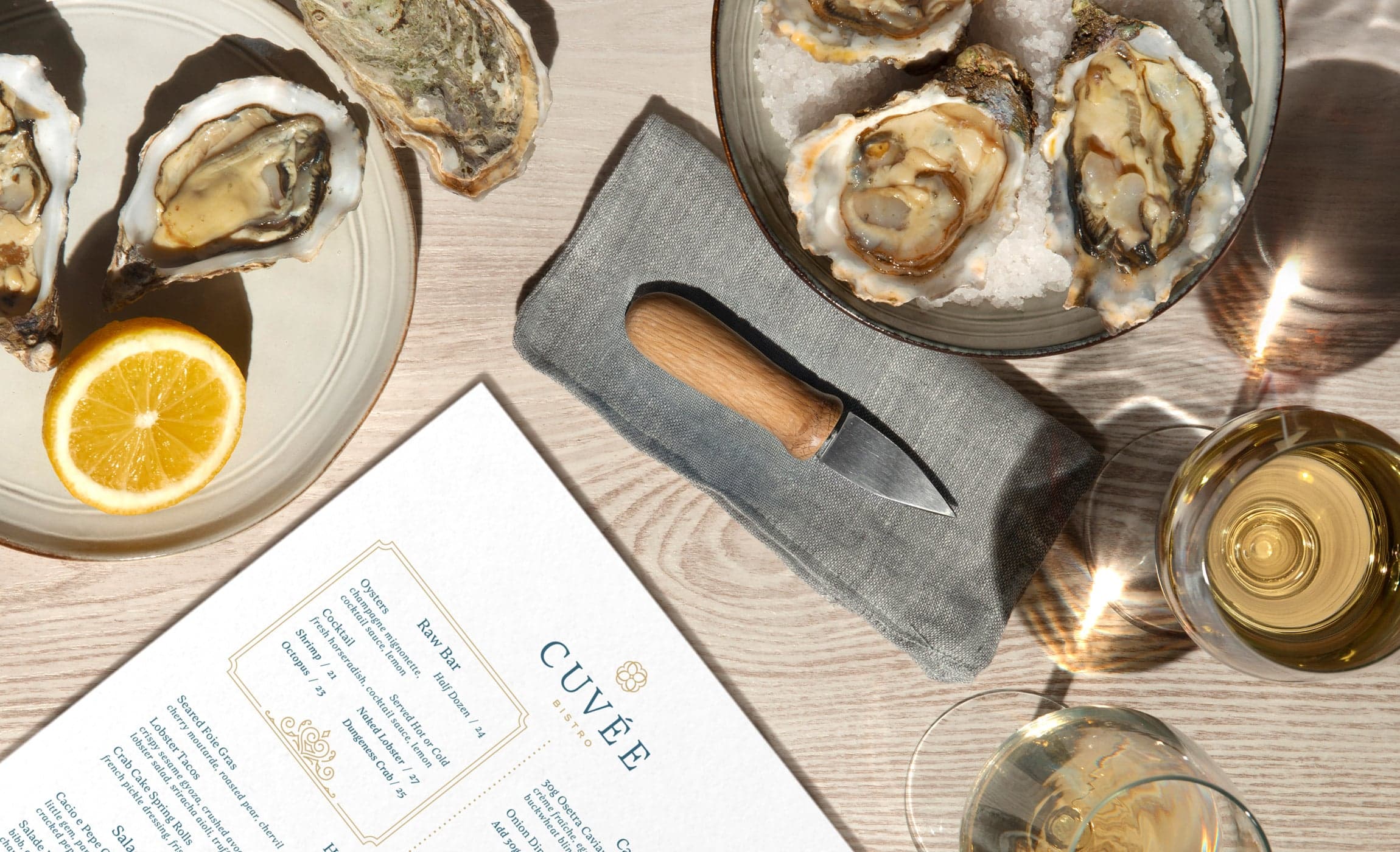 oyster plate on table with a knife and menu